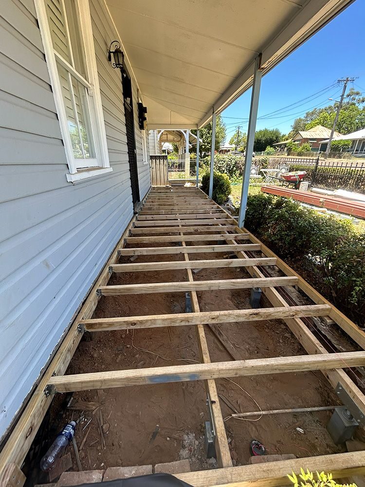 New timber deck framing installed along the side of a weatherboard home