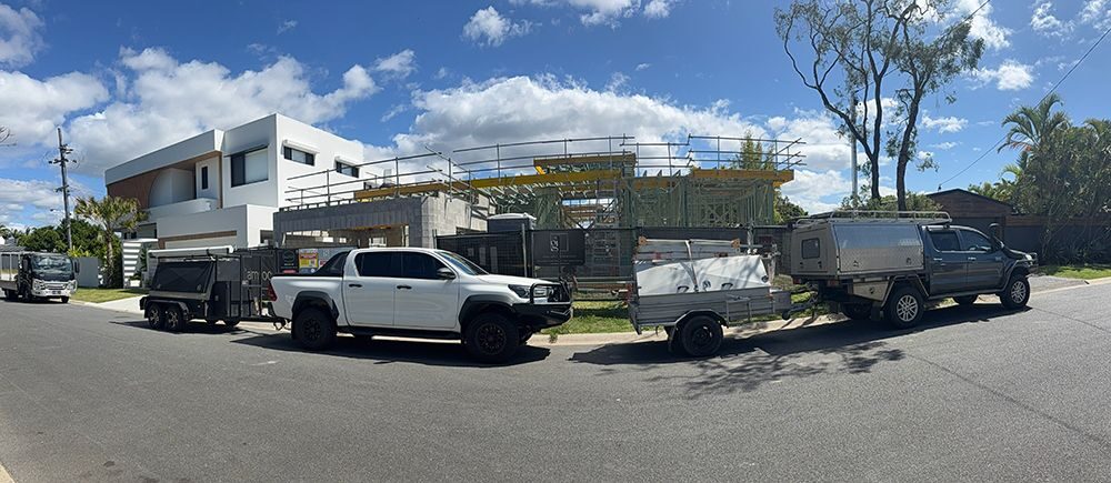 Jack Power Constructions vehicles and trailers parked at an active Gold Coast build site